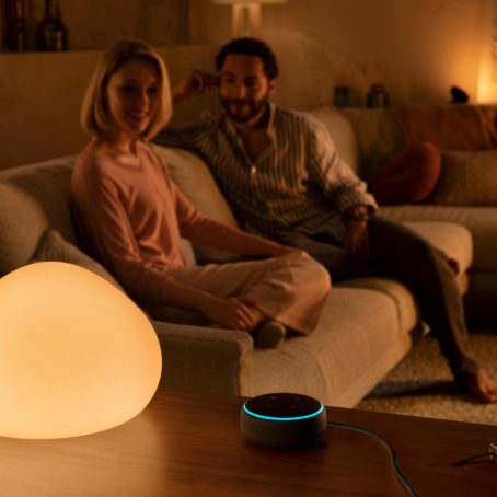Man and woman in doorway lit by blue smart LED strip